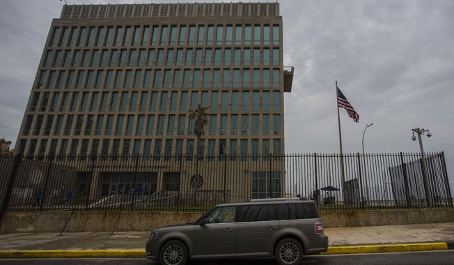 A car is parked outside the compound of the United States embassy in Havana, Cuba, Friday, Sept. 29, 2017. The United States issued an ominous warning to Americans on Friday to stay away from Cuba and ordered home more than half the U.S. diplomatic corps, acknowledging neither the Cubans nor America’s FBI can figure out who or what is responsible for months of mysterious health ailments. (AP Photo/Desmond Boylan)