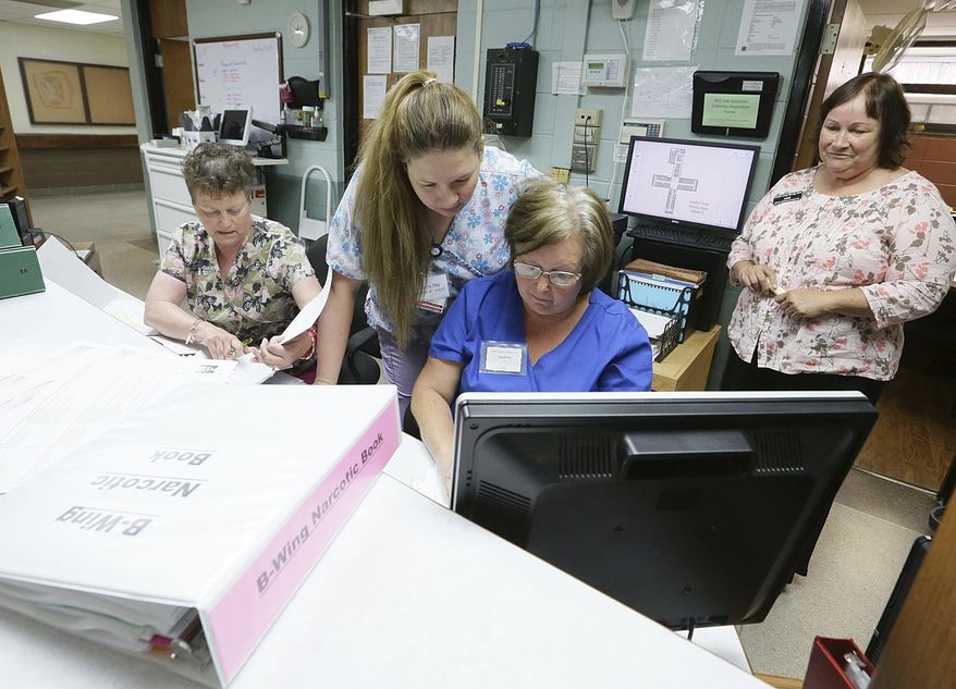 In this Sept. 12, 2017 photo, La Salle County Nursing Home nurses, from left, Cathy Balzarini, Raylene Rankin, Carrie Becker, and Jane DePaoli, look up patient records as people begIn moving back into the home that was evacuated due to a tornado on Feb. 28, 2017 in Ottawa, Ill. When the tornado hit , the 68 residents were evacuated by midnight, either by going home with family or to one of five other facilities taking in residents. After repairs, former residents continue to return. (Scott Anderson /NewsTribune via AP)