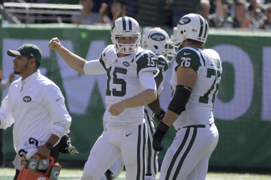 New York Jets quarterback Josh McCown (15), center, reacts after teammate Bilal Powell scored a touchdown during the first half of an NFL football game against the Jacksonville Jaguars, Sunday, Oct. 1, 2017, in East Rutherford, N.J. (AP Photo/Bill Kostroun)