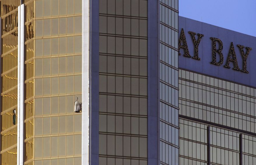 Drapes billow out of a broken window at the Mandalay Bay resort and casino Monday, Oct. 2, 2017, on the Las Vegas Strip following a deadly shooting at a music festival in Las Vegas. A gunman was found dead inside a hotel room. (AP Photo/Ronda Churchill)