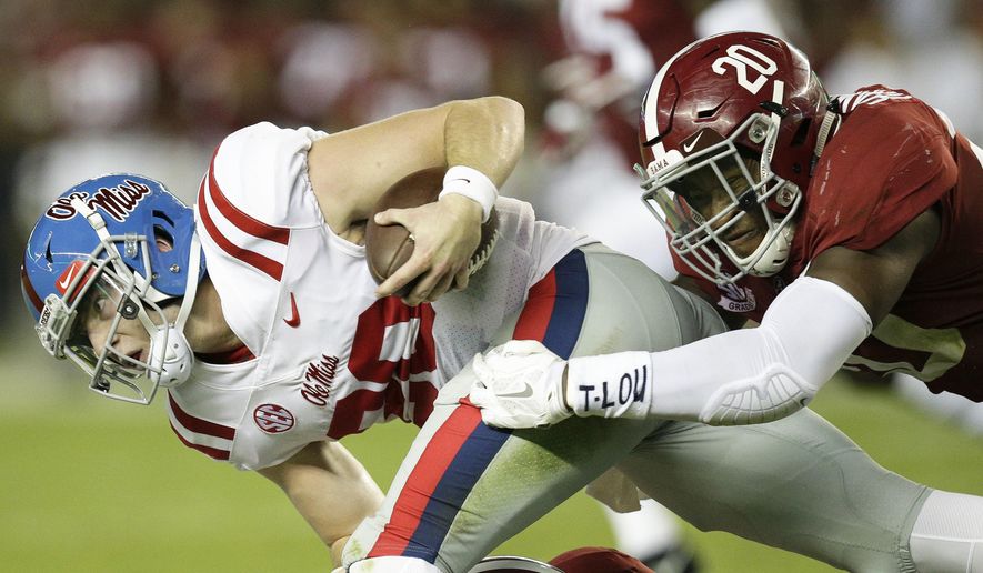 Mississippi quarterback Shea Patterson is tackled by Alabama linebacker Shaun Dion Hamilton during the first half of an NCAA college football game, Saturday, Sept. 30, 2017, in Tuscaloosa, Ala. (AP Photo/Brynn Anderson)