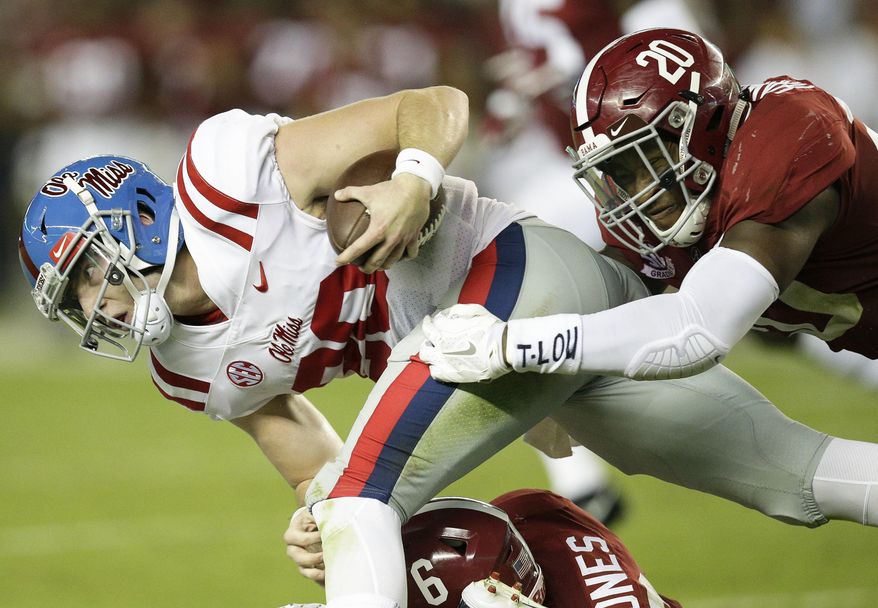 Mississippi quarterback Shea Patterson is tackled by Alabama linebacker Shaun Dion Hamilton during the first half of an NCAA college football game, Saturday, Sept. 30, 2017, in Tuscaloosa, Ala. (AP Photo/Brynn Anderson)