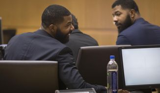 Marcus Morris, left, and Markieff Morris attend closing arguments Monday, Oct. 2, 2017, in Maricopa County Superior Court in Phoenix. The Morris brothers are accused of helping three other people beat Erik Hood two years ago. (Mark Henle/The Arizona Republic via AP)