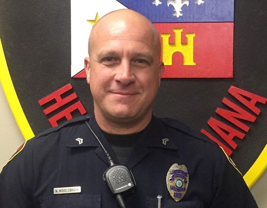 This photo provided by the Lafayette Police Department shows Cpl. Michael Paul Middlebrook, a nine-year patrol veteran who was shot and killed in the line of duty late Sunday, Oct. 1, 2017. Louisiana State Police say he was killed late Sunday after responding to a call about a shooting at a Big Boy convenience store. (Lafayette Police Department via AP)
