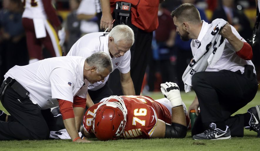 Kansas City Chiefs offensive lineman Laurent Duvernay-Tardif (76) is tended to by trainers during the first half of an NFL football game against the Washington Redskins in Kansas City, Mo., Monday, Oct. 2, 2017. (AP Photo/Charlie Riedel)