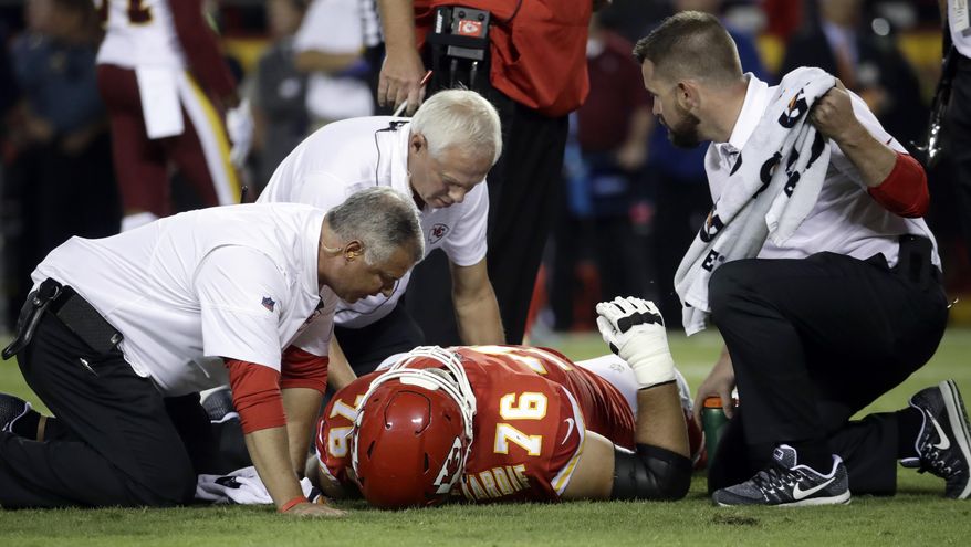 Kansas City Chiefs offensive lineman Laurent Duvernay-Tardif (76) is tended to by trainers during the first half of an NFL football game against the Washington Redskins in Kansas City, Mo., Monday, Oct. 2, 2017. (AP Photo/Charlie Riedel)