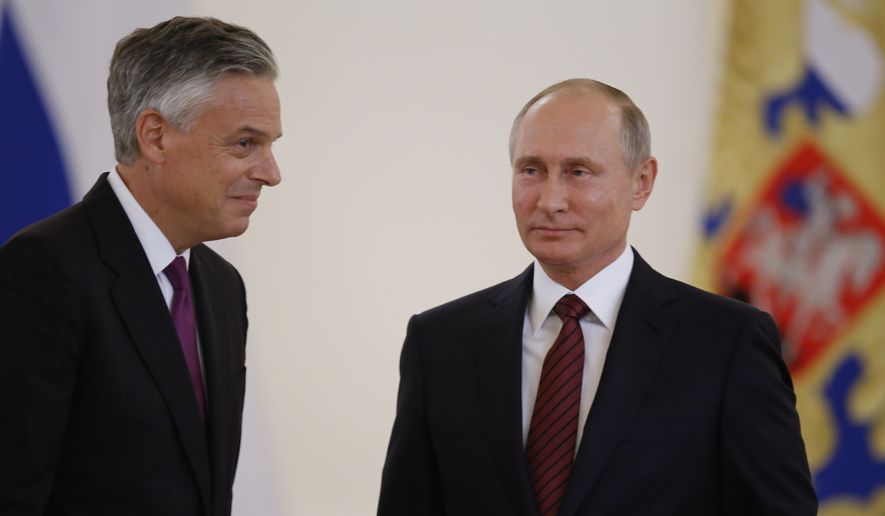 U.S. Ambassador Jon Huntsman (left) walks after presenting credentials to Russian President Vladimir Putin (right) during a ceremony in the Kremlin in Moscow on Oct. 3, 2017. The new U.S. Ambassador to Russia presented his credentials to President Vladimir Putin in the Kremlin on Monday amid investigations into Moscow&#39;s meddling in the 2016 U.S. elections. (Associated Press) **FILE**