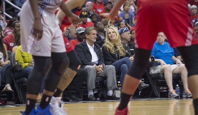 In this image taken Sept. 17, 20, 2017, and provided by Monumental Sports &amp; Entertainment, Ted Leonsis, left, chairman and CEO of Monumental Sports &amp; Entertainment, sits with billionaire executive Laurene Powell Jobs during a basketball game in Washington, D.C. Powell Jobs has agreed to buy a 20 percent stake in Ted Leonsis&#x27; Monumental Sports &amp; Entertainment., pending approval from the NBA and NHL. Monumental owns the Washington Wizards, Capitals, Mystics and the Arena Football League&#x27;s Washington Valor and Baltimore Brigade. (Barbara Kinney/Monumental Sports &amp; Entertainment via AP) **FILE**