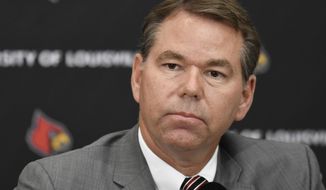 Vince Tyra speaks to reporters after being named acting athletic director at Louisville, Tuesday, Oct. 3, 2017, in Louisville, Ky. Athletic director Tom Jurich is on paid administrative leave as the school addresses its involvement in a federal bribery investigation of men&#39;s basketball recruits. (AP Photo/Timothy D. Easley)