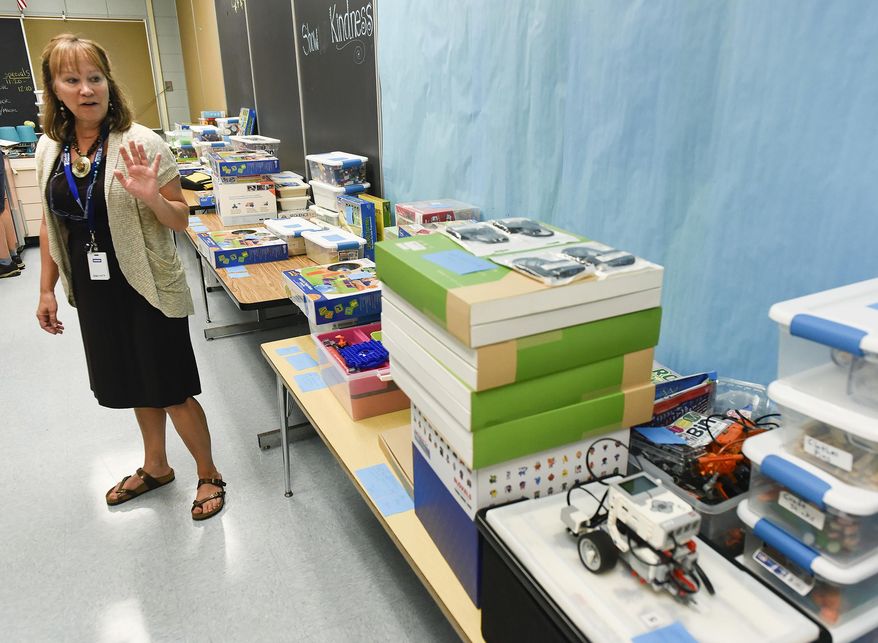In this Thursday, Sept. 14, 2017 photo, Jenny McNew, media specialist, show the STEM project boxes for different grades at Talahi Community School in St. Cloud, Minn. (Jason Wachter/St. Cloud Times via AP)