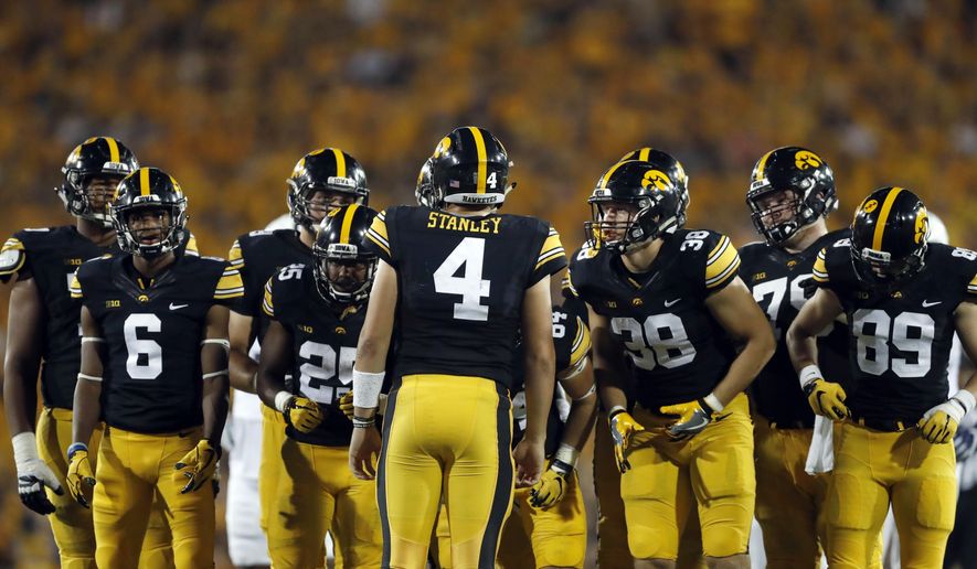 FILE - In this Sept. 23, 2017, file photo, Iowa quarterback Nate Stanley (4) huddles with his team during the second half of an NCAA college football game against Penn State in Iowa City, Iowa. The strangest thing has happened to the Iowa Hawkeyes. They suddenly can't run the ball, and it's threatening their once-promising season. (AP Photo/Jeff Roberson)
