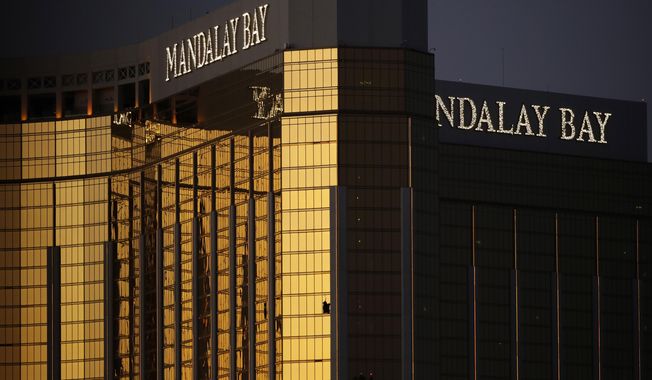 Windows are broken at the Mandalay Bay resort and casino, Tuesday, Oct. 3, 2017, in Las Vegas. Authorities said Stephen Craig Paddock broke the windows and began firing with a cache of weapons, killing dozens and injuring hundreds. (AP Photo/John Locher)