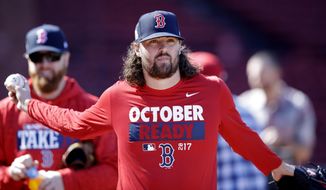 Boston Red Sox relief pitcher Heath Hembree stretches out as he heads to the outfield during baseball practice at Fenway Park in Boston, Tuesday, Oct. 3, 2017. The Red Sox face the Houston Astros in the American League Division playoff series. (AP Photo/Charles Krupa)