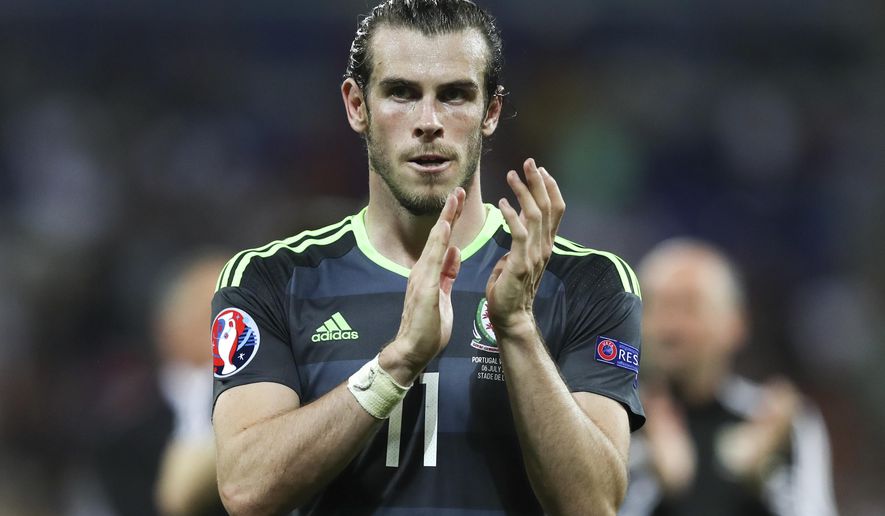 FILE - In this Wednesday, July 6, 2016 file photo, Wales&#39;s Gareth Bale acknowledges the fans at the end of their Euro 2016 semifinal soccer match against Portugal, at the Grand Stade in Decines-­Charpieu, France. They were the revelation of the 2016 European Championship, a Wales team of mostly journeymen - not counting its galactico, Gareth Bale - somehow reaching the semifinals of the country’s first major soccer tournament in nearly 60 years. Their players virtually became overnight sensations. They were ahead of arch-rival England in the FIFA rankings, in 11th place when five years previously they were 117th. The comedown was sobering, if not entirely unexpected given the expectations foisted upon them.  (AP Photo/Thanassis Stavrakis, file)