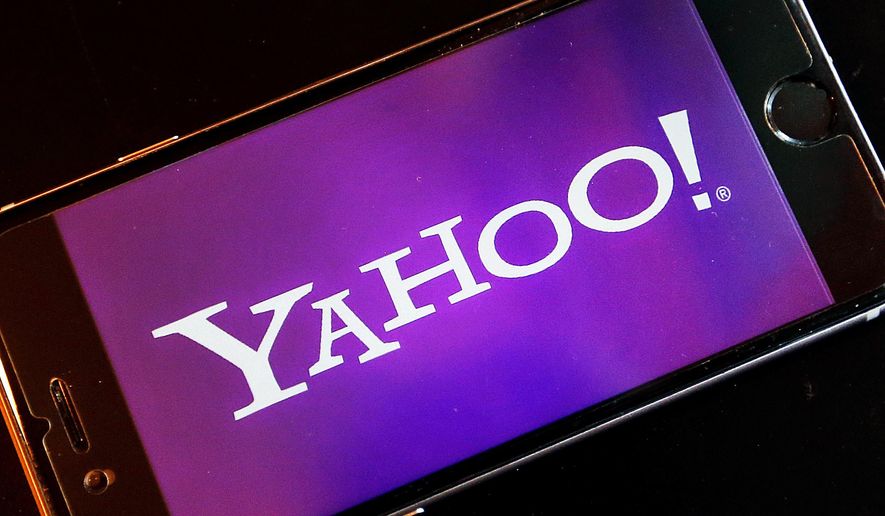In this Dec. 15, 2016, file photo, the Yahoo logo appears on a smartphone in Frankfurt, Germany. (AP Photo/Michael Probst, File)