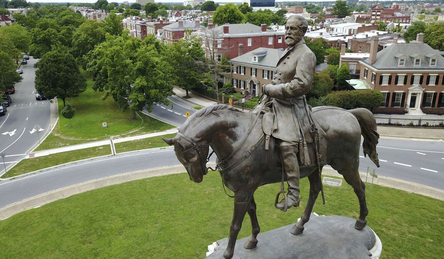  This Tuesday June 27, 2017, file photo shows the statue of Confederate General Robert E. Lee that stands in the middle of a traffic circle on Monument Avenue in Richmond, Va.  (AP Photo/Steve Helber, File) **FILE**