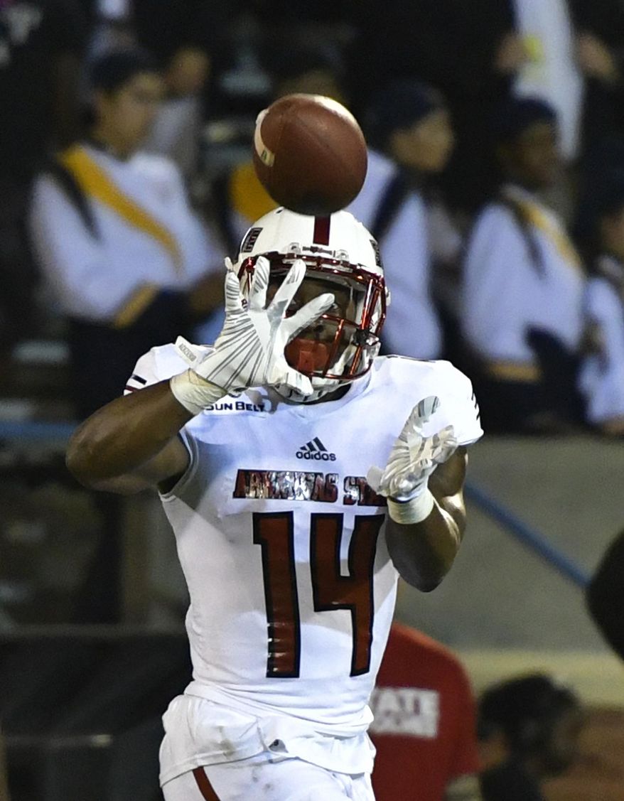 Arkansas State wide receiver Chris Murray hauls in a pass from quarterback Justice Hansen on the way to a 56-yard touchdown during the second quarter against Georgia Southern in an NCAA college football game at Paulson Stadium in Statesboro, Ga., Wednesday, Oct. 4, 2017. (Scott Bryant/The Statesboro Herald via AP)