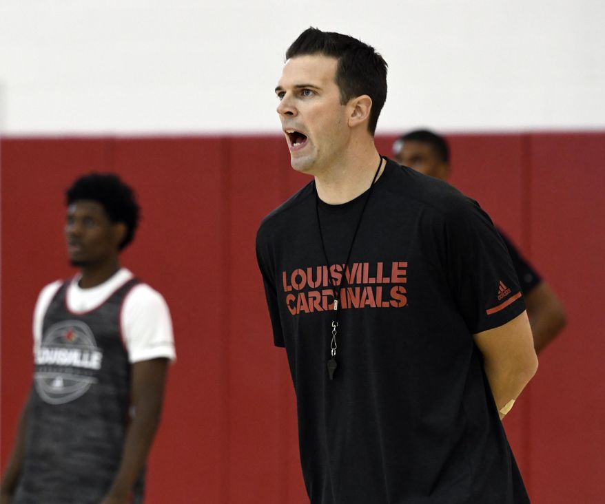University of Louisville interim men's head basketball coach David Padgett shouts instructions to his team as they participate in drills during practice, Wednesday, Oct. 4, 2017, in Louisville, Ky. (AP Photo/Timothy D. Easley)