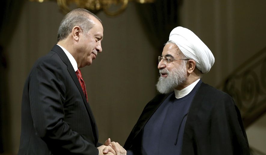 Iranian President Hassan Rouhani, right, and Turkish President Recep Tayyip Erdogan shake hands at the conclusion of their joint press conference at the Saadabad Palace in Tehran, Iran, Wednesday, Oct. 4, 2017. With Turkey&#x27;s president by his side, Iranian President Hassan Rouhani pledged Wednesday that they would ensure borders in the region remain unchanged after the recent Kurdish independence referendum in Iraq. (AP Photo/Ebrahim Noroozi)