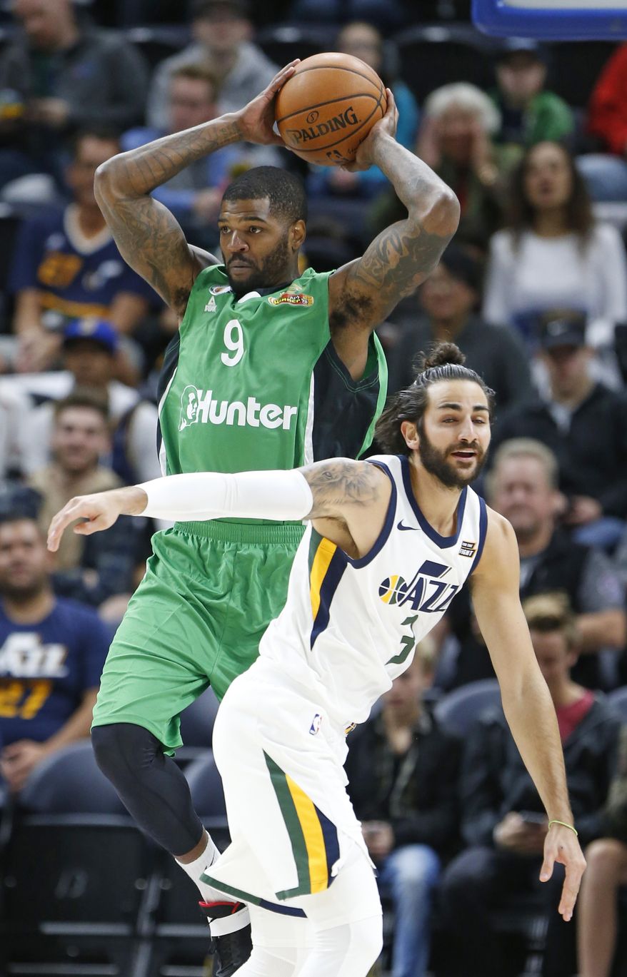Maccabi Haifa center Josh Smith (9) passes the ball as Utah Jazz guard Ricky Rubio (3) defends during the first half of a preseason NBA basketball game Wednesday, Oct. 4, 2017, in Salt Lake City. (AP Photo/Rick Bowmer)
