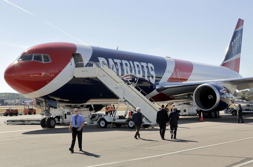 The New England Patriots customized Boeing 767 passenger jet sits on the tarmac, Wednesday, Oct. 4, 2017, at T.F. Green Airport, in Warwick, R.I. The NFL football team are to fly in the aircraft, which is painted with the team's logo and red-white-and-blue colors, and includes the Pats' five Lombardi trophies painted on the tail, on their way to Florida, where they play the Tampa Bay Buccaneers on Thursday, Oct. 5. (AP Photo/Steven Senne)