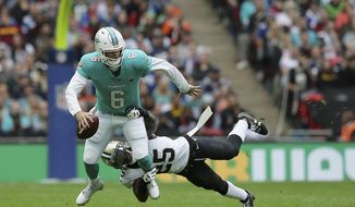 Miami Dolphins quarterback Jay Cutler (6) is tackled by New Orleans Saints defensive back Rafael Bush (25) during the first half of an NFL football game at Wembley Stadium in London, Sunday Oct. 1, 2017. (AP Photo/Tim Ireland)