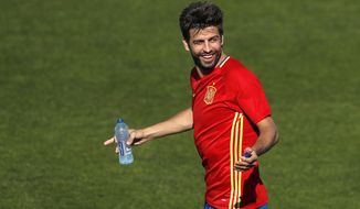 FILE- In this Friday, June 24, 2016 file photo, Spain&#39;s Gerard Pique gestures during a training session at the Sports Complex Marcel Gaillard in Saint Martin de Re in France. Spain coach Julen Lopetegui praised Gerard Pique&#39;s commitment to the national team and called on the squad to be focused only on soccer despite the crisis involving Catalonia&#39;s push for independence. (AP Photo/Manu Fernandez, File)