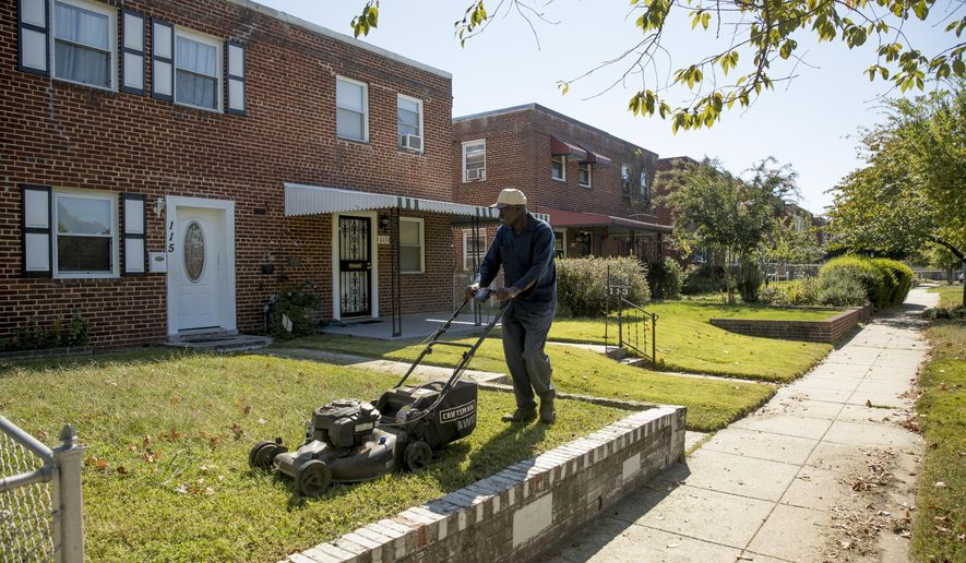 Johnny Wilson, a friend of the property owner, mows the lawn in Washington, Wednesday, Oct. 4, 2017, where a late-night party that turned a vacant home into something resembling a strip club will be at the center of arguments before the Supreme Court. The court is being asked to decide whether police had sufficient reason to arrest the group. (AP Photo/Andrew Harnik)