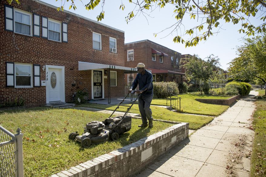 Johnny Wilson, a friend of the property owner, mows the lawn in Washington, Wednesday, Oct. 4, 2017, where a late-night party that turned a vacant home into something resembling a strip club will be at the center of arguments before the Supreme Court. The court is being asked to decide whether police had sufficient reason to arrest the group. (AP Photo/Andrew Harnik)