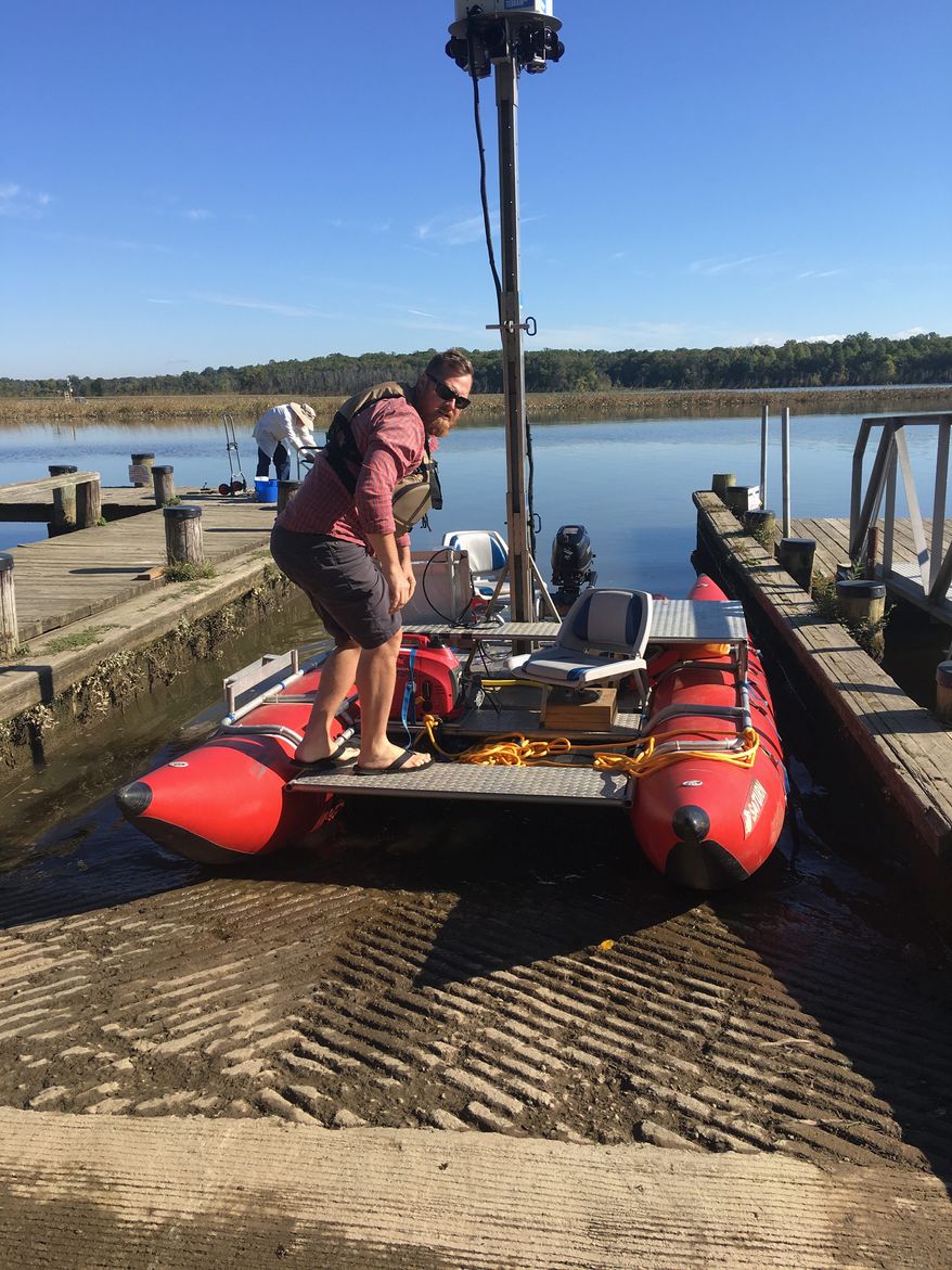 Ryan Abrahamsen of Terrain 360 stands aboard his custom raft designed to take photos and document the length of some of the rivers of the Chesapeake Bay, as well as raise awareness about conservation efforts. (Laura Kelly/The Washington Times)