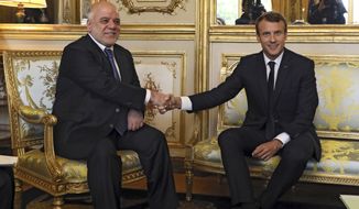 French president Emmanuel Macron, right, shakes hands with Iraqi Prime minister Haider al-Abadi prior to their meeting at the Elysee palace in Paris, Thursday, Oct. 5, 2017. Al-Abadi is meeting with French President Emmanuel Macron for talks on the international fight against Islamic State group extremists and rebuilding Iraq&#39;s economy.(Ludovic Marin, Pool via AP)