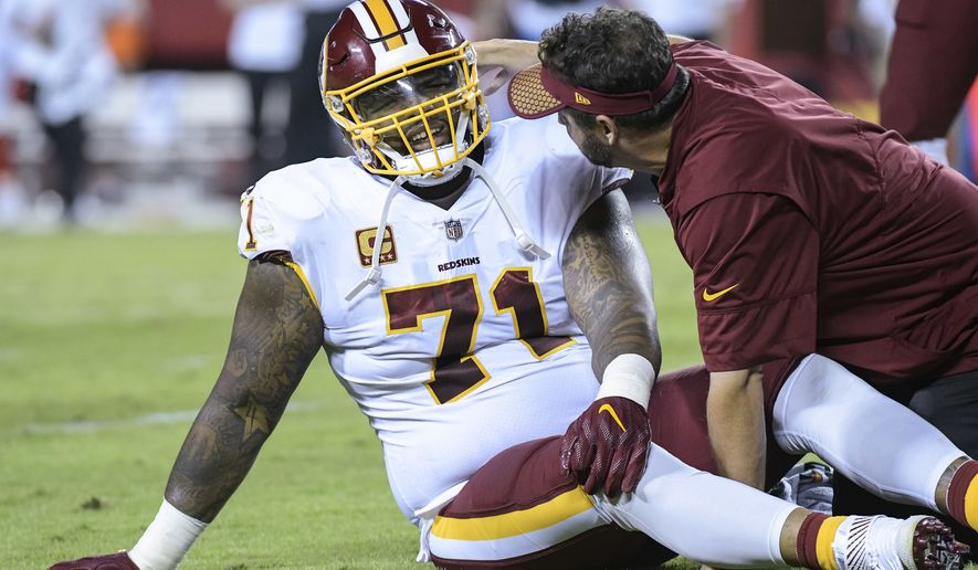 Washington Redskins offensive tackle Trent Williams (71) is treated during the first half of an NFL football game in Kansas City, Mo., Monday, October 2, 2017. (AP Photo/Reed Hoffmann)