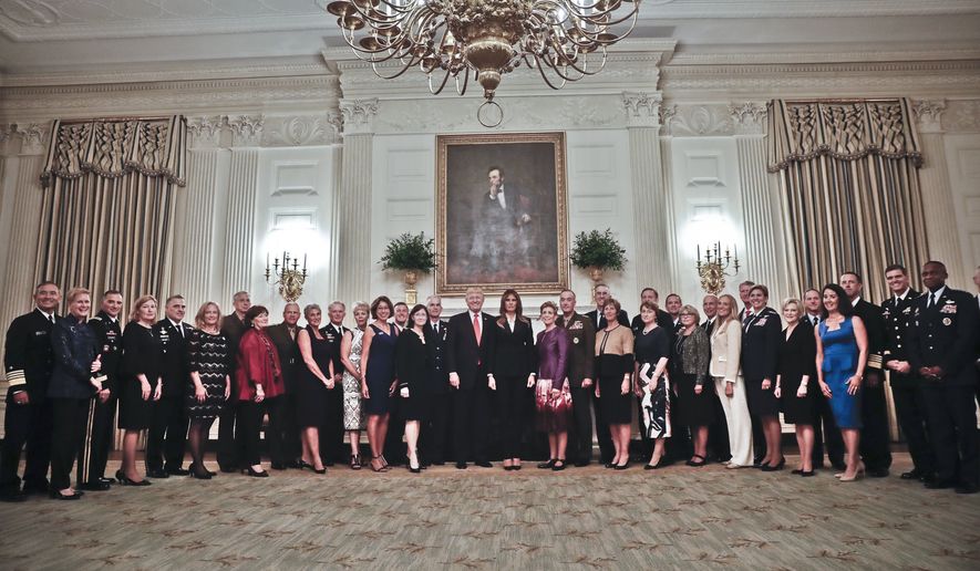 President Donald Trump and first lady Melania Trump, center, poses for a group photo with Senior Military leaders and spouses in the State Dining Room of the White House in Washington, Thursday, Oct. 5, 2017. Trump was hosting the dinner for the group this evening. (AP Photo/Pablo Martinez Monsivais)