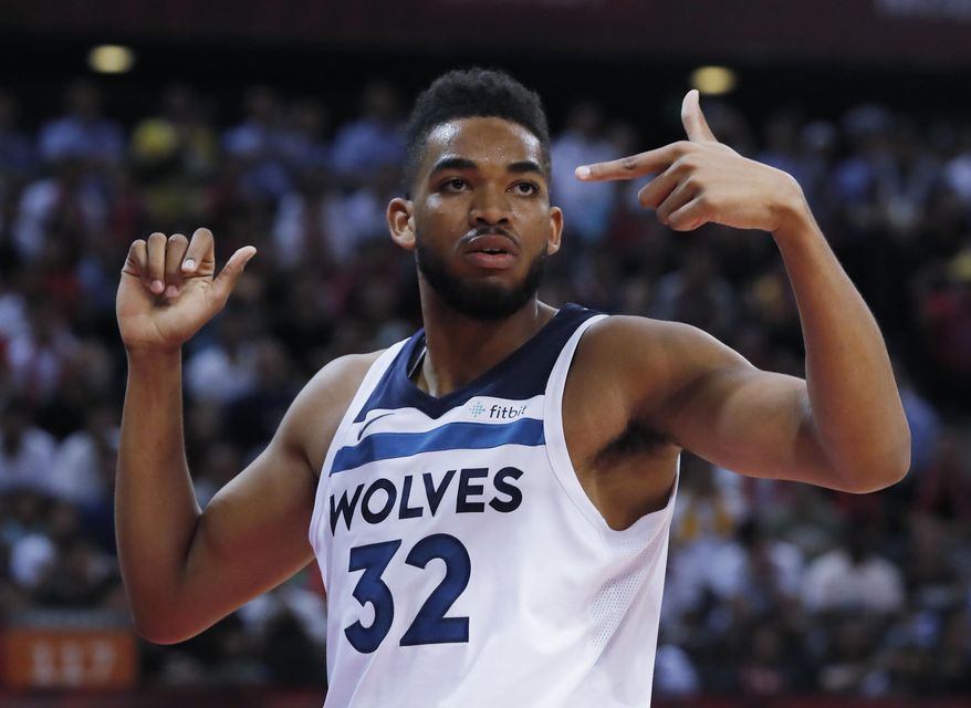 Minnesota Timberwolves' Karl-Anthony Towns talks to his teammate during the basketball match of the 2017 NBA Global Games against Golden State Warriors in Shenzhen, south China's Guangdong province, Thursday, Oct. 5, 2017. (AP Photo/Kin Cheung)