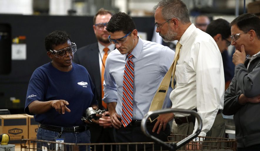 Dixon Valve &amp;amp; Coupling Company employee Toni Durant, left, speaks with Speaker of the House Paul Ryan, R-Wis., center, and Rep. Andy Harris, R-Md., right, during a factory tour prior to a tax reform town hall with employees in Chestertown, Md., Thursday, Oct. 5, 2017. (AP Photo/Patrick Semansky)