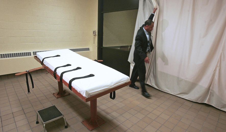 FILE – In this Nov. 2005 file photo, Larry Greene, public information director of the Southern Ohio Correctional Facility, demonstrates how a curtain is pulled between the death chamber and witness room at the prison in Lucasville, Ohio. With Ohio's next execution scheduled for Wednesday, Nov. 15, 2017, the state has sufficiently replenished its lethal drug supply to carry out nearly 20 executions under certain conditions, according to records obtained by The Associated Press. (AP Photo/Kiichiro Sato, File)