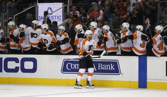 Philadelphia Flyers center Claude Giroux (28) is congratulated by teammates after scoring a goal against the San Jose Sharks during the first period of an NHL hockey game, Wednesday, Oct. 4, 2017, in San Jose, Calif. (AP Photo/Tony Avelar)