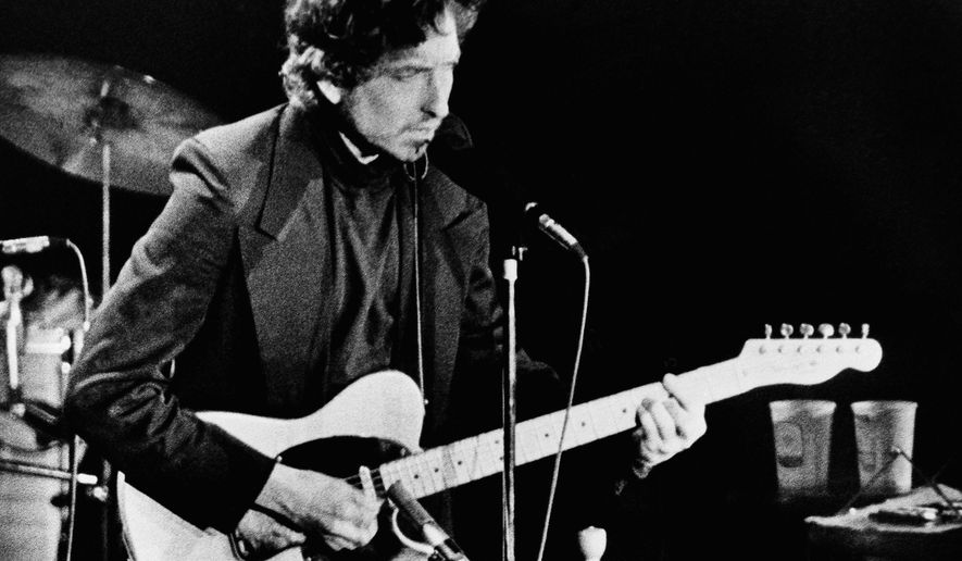 FILE - In this January 29, 1974 file photo, singer and poet Bob Dylan performs at the Nassau Coliseum, in Uniondale, New York. Dylan was awarded the 2016 Nobel Prize in Literature, one of the most surprising decisions in award's history. The Swedish Academy praised Dylan "for having created new poetic expressions within the great American song tradition." This year's winner is set to be announced on Thursday, Oct. 5, 2017. ( AP Photo/Ron Frehm, File)