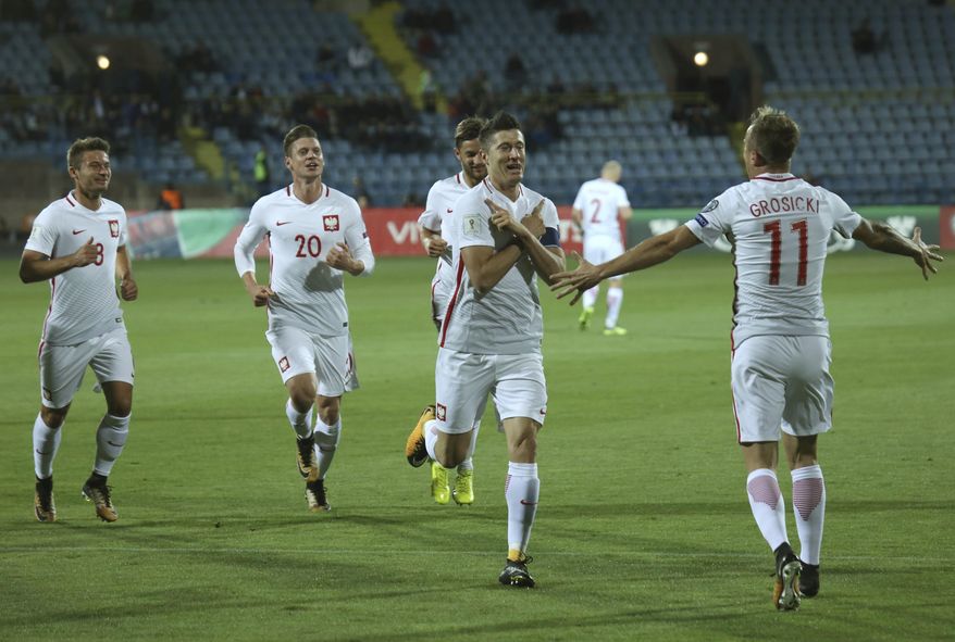 Poland's Robert Lewandowski, second from right, celebrates scoring his goal during the World Cup Group E qualifying soccer match between Armenia and Poland in Yerevan, Armenia, Thursday, Oct. 5, 2017. (Hrant Khachatryan/PAN Photo via AP)