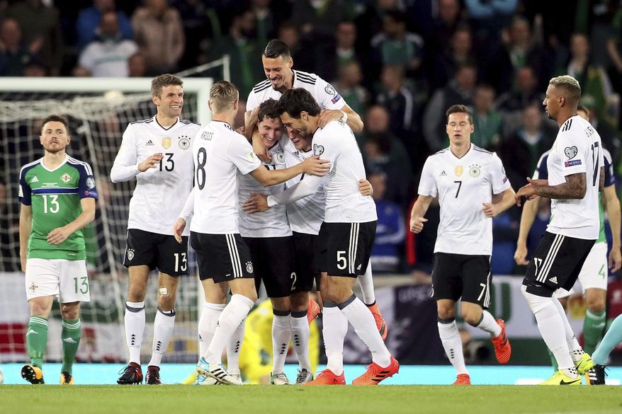 Germany's Sebastian Rudy, fourth from left, celebrates scoring his side's first goal of the game with his team-mates during the World Cup Group C qualifying soccer match between Germany and Northern Ireland at Windsor Park, Belfast, Northern Ireland. Thursday, Oct. 5, 2017. (Brian Lawless/PA via AP)