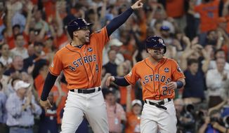 Houston Astros&#39; George Springer (4) and Jose Altuve (27) celebrate after they scored on teammate Carlos Correa&#39;s double in Game 2 of baseball&#39;s American League Division Series against the Boston Red Sox, Friday, Oct. 6, 2017, in Houston. (AP Photo/David J. Phillip)