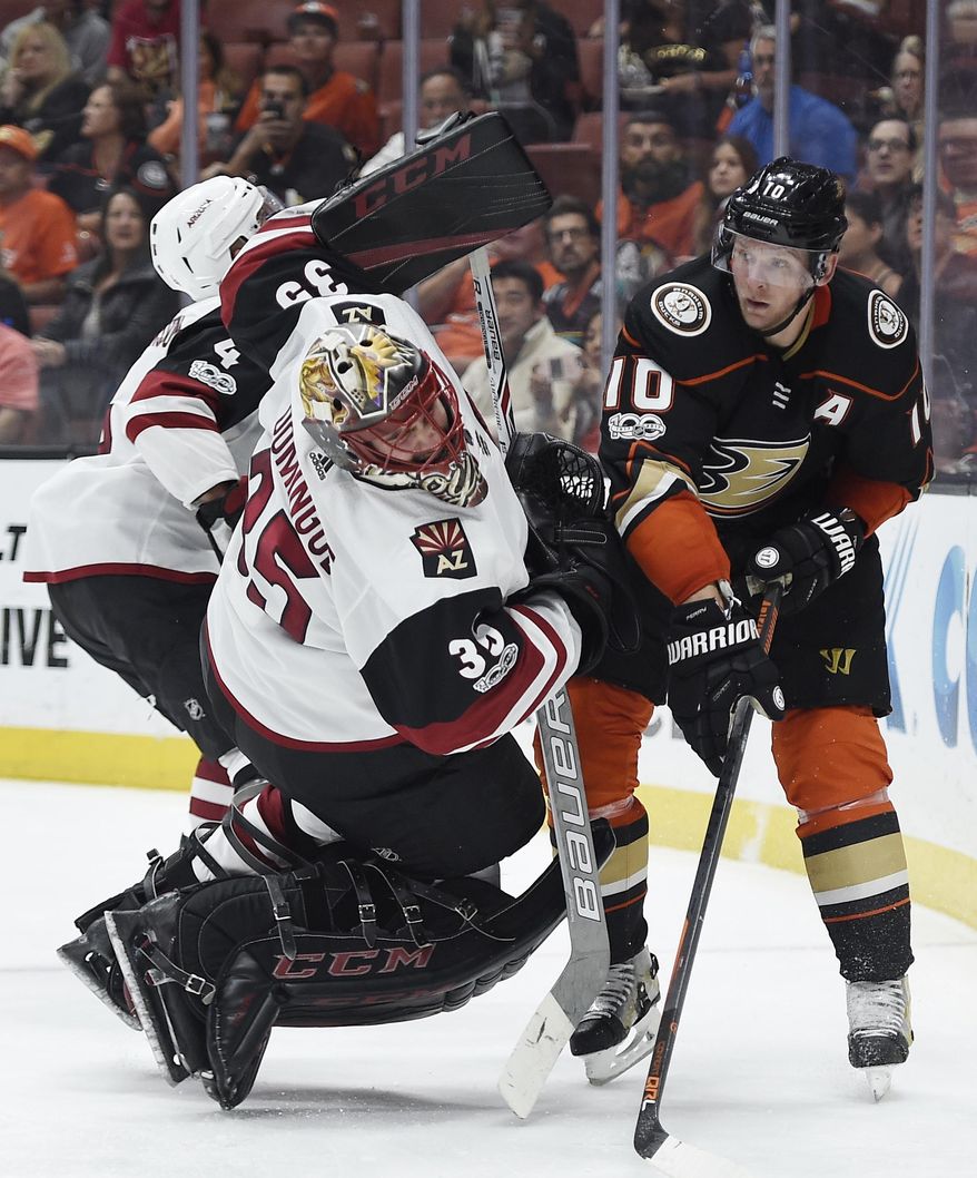 Anaheim Ducks right wing Corey Perry, right, trips Arizona Coyotes goalie Louis Domingue resulting in a goalie interference penalty during the second period of an NHL hockey game in Anaheim, Calif., Thursday, Oct. 5, 2017. (AP Photo/Kelvin Kuo)