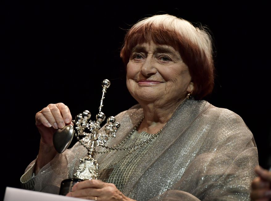 FILE - In this Sept. 24, 2017 file photo, film director Agnes Varda holds the Donostia Award for her contribution to the cinema at the 65th San Sebastian Film Festival, in San Sebastian, northern Spain. Varda reflects on her life in cinema, her status as a trailblazer for female filmmakers and the lifetime achievement award she'll receive from the Academy Awards. (AP Photo/Alvaro Barrientos, File)