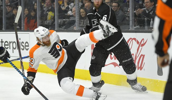 Philadelphia Flyers right wing Jakub Voracek, of the Czech Republic, falls as he battles for the puck with Los Angeles Kings defenseman Jake Muzzin during the first period of an NHL hockey game, Thursday, Oct. 5, 2017, in Los Angeles. (AP Photo/Mark J. Terrill)