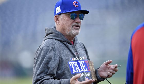Chicago Cubs manager Joe Maddon gestures on the field during practice at Nationals Park, Thursday, Oct. 5, 2017, in Washington. Game 1 of the National League Division Series against the Washington Nationals is on Friday. (AP Photo/Nick Wass)
