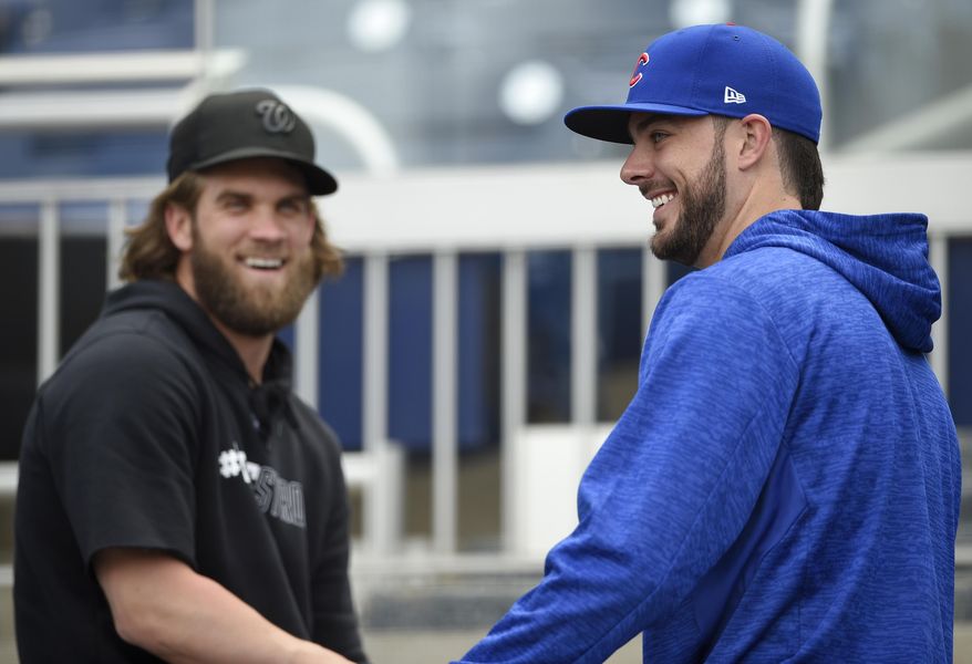 Washington Nationals' Bryce Harper, left, laughs with Chicago Cubs' Kris Bryant, right, at Nationals Park, Thursday, Oct. 5, 2017, in Washington. Game 1 of the National League Division Series is on Friday. (AP Photo/Nick Wass)