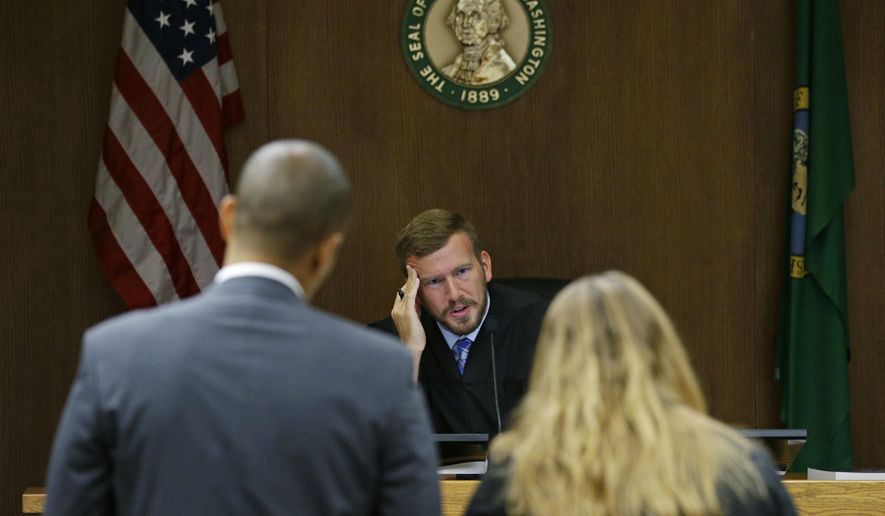 Judge Chris Lanese talks with attorneys during a scheduling hearing in Thurston County Superior Court in Olympia, Wash., for a lawsuit against the Washington Legislature brought by a coalition of news organizations, and led by The Associated Press, on Friday, Oct. 6, 2017. The suit challenges lawmakers' claim that the state's public records law excludes them from stricter disclosure rules that apply to other elected officials and agencies. (AP Photo/Ted S. Warren)