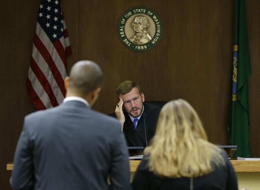 Judge Chris Lanese talks with attorneys during a scheduling hearing in Thurston County Superior Court in Olympia, Wash., for a lawsuit against the Washington Legislature brought by a coalition of news organizations, and led by The Associated Press, on Friday, Oct. 6, 2017. The suit challenges lawmakers' claim that the state's public records law excludes them from stricter disclosure rules that apply to other elected officials and agencies. (AP Photo/Ted S. Warren)