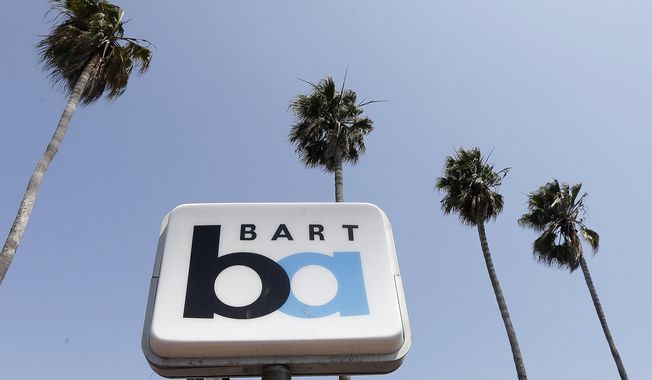 FILE--In this July 1, 2013, file photo, a Bay Area Rapid Transit (BART) sign is seen at the 24th Street Mission station in San Francisco. The California Public Utilities Commission on Friday, Oct. 6, 2017, issued a decision by an Administrative Law Judge that penalizes BART for two fatalities that occurred in 2013 in Contra Costa County. (AP Photo/Jeff Chiu, file)