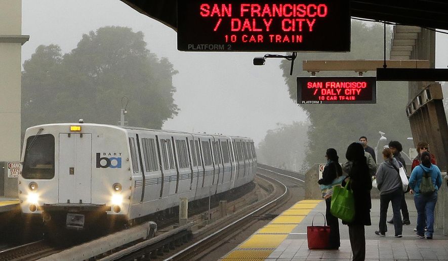 In this Oct. 22, 2013, file photo, Bay Area Rapid Transit (BART) passengers wait for a train in Oakland, Calif. (AP Photo/Ben Margot, File)